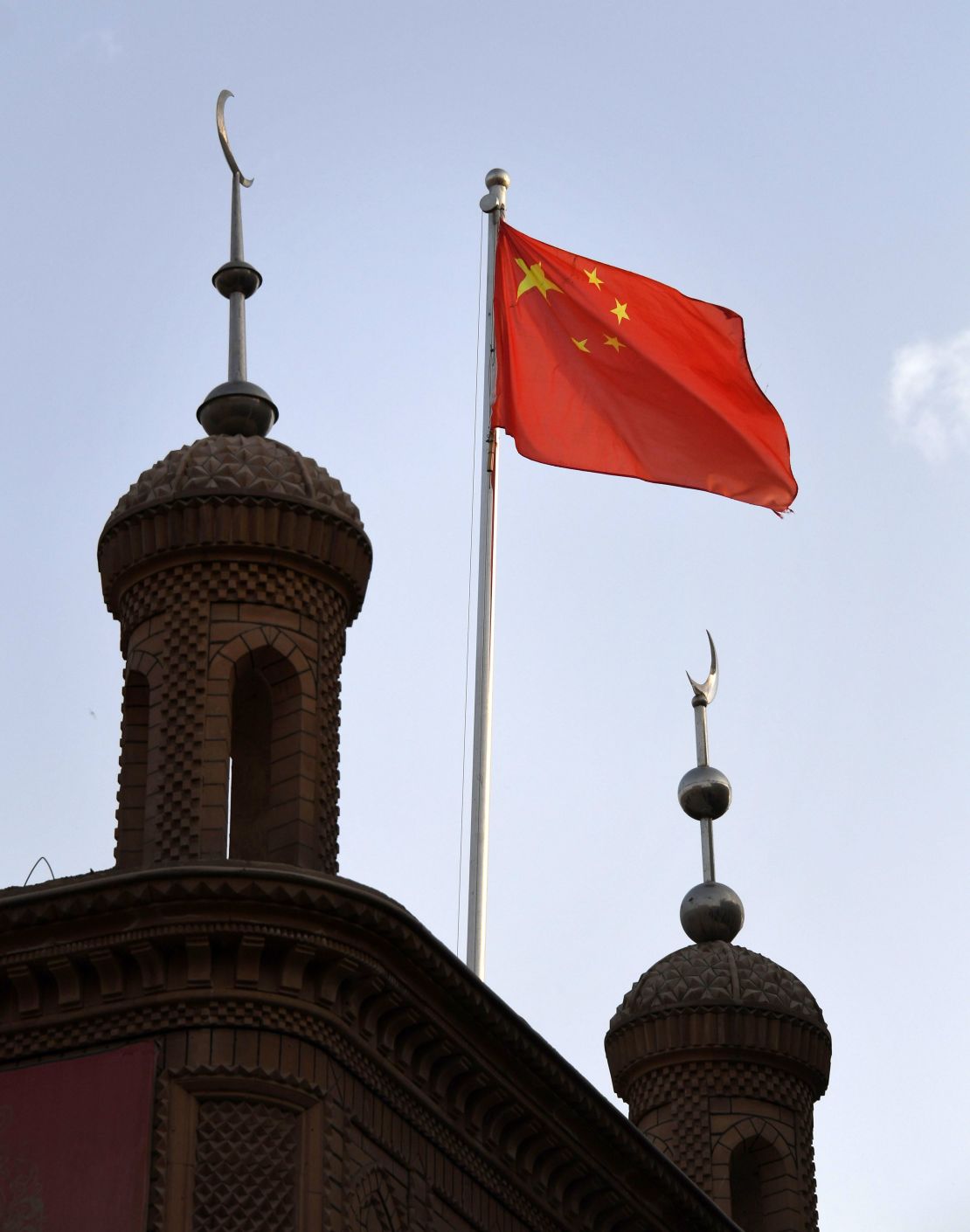 The Chinese flag flies over the Juma mosque in the restored old city area of Kashgar, in China's western Xinjiang region, on June 4, 2019.
