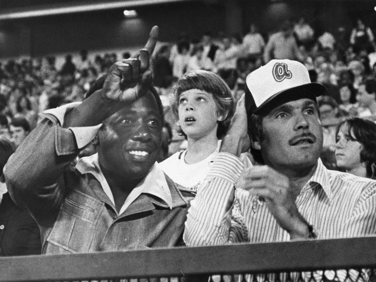Aaron watches a Braves game with team owner Ted Turner in 1977.