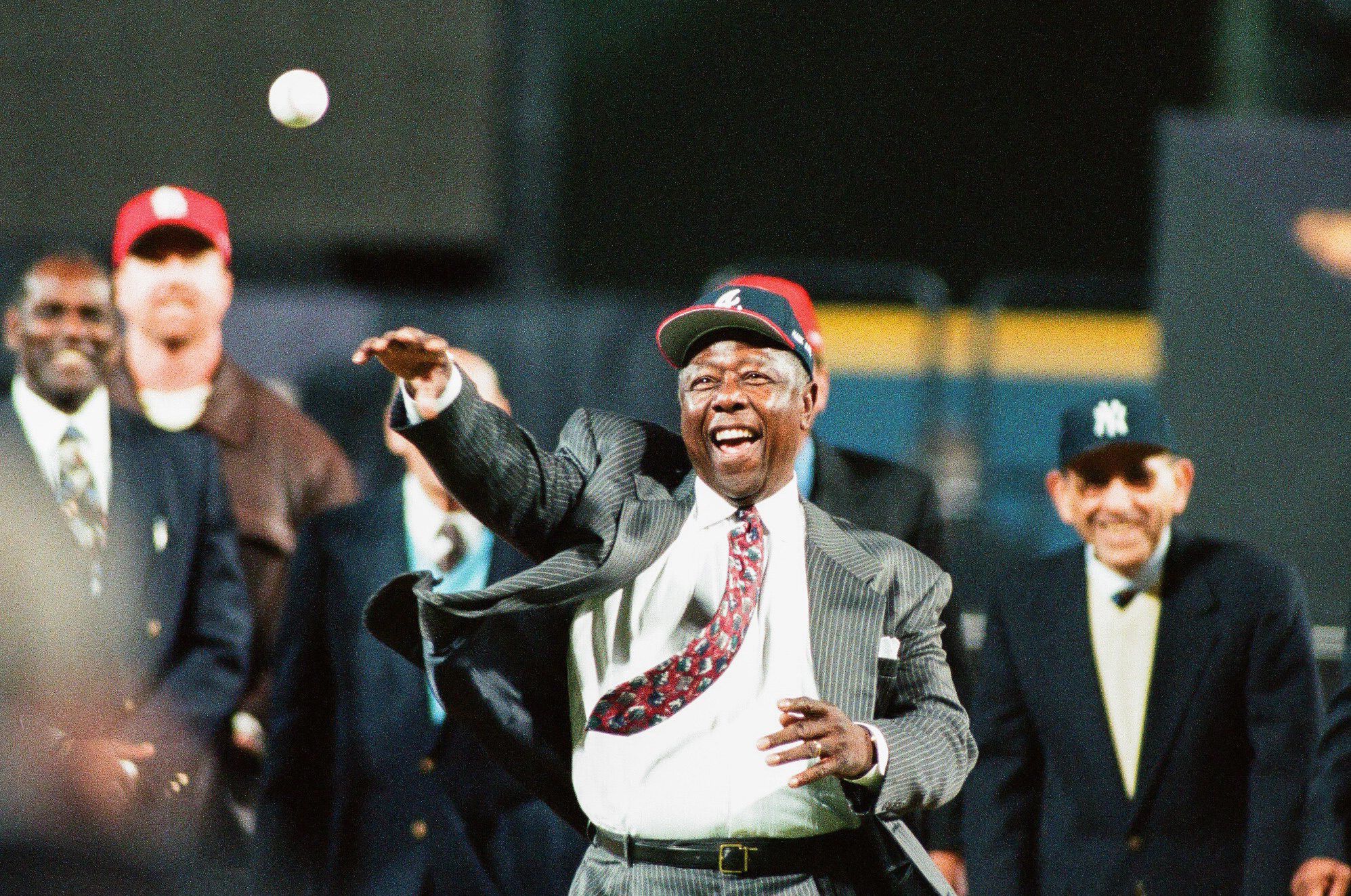 FILE - In this Sept. 30, 1969, file photo, a Major League Baseball 100th anniversary  patch is shown on the uniform of Atlanta Braves team captain Hank Aaron,  left, as he watches