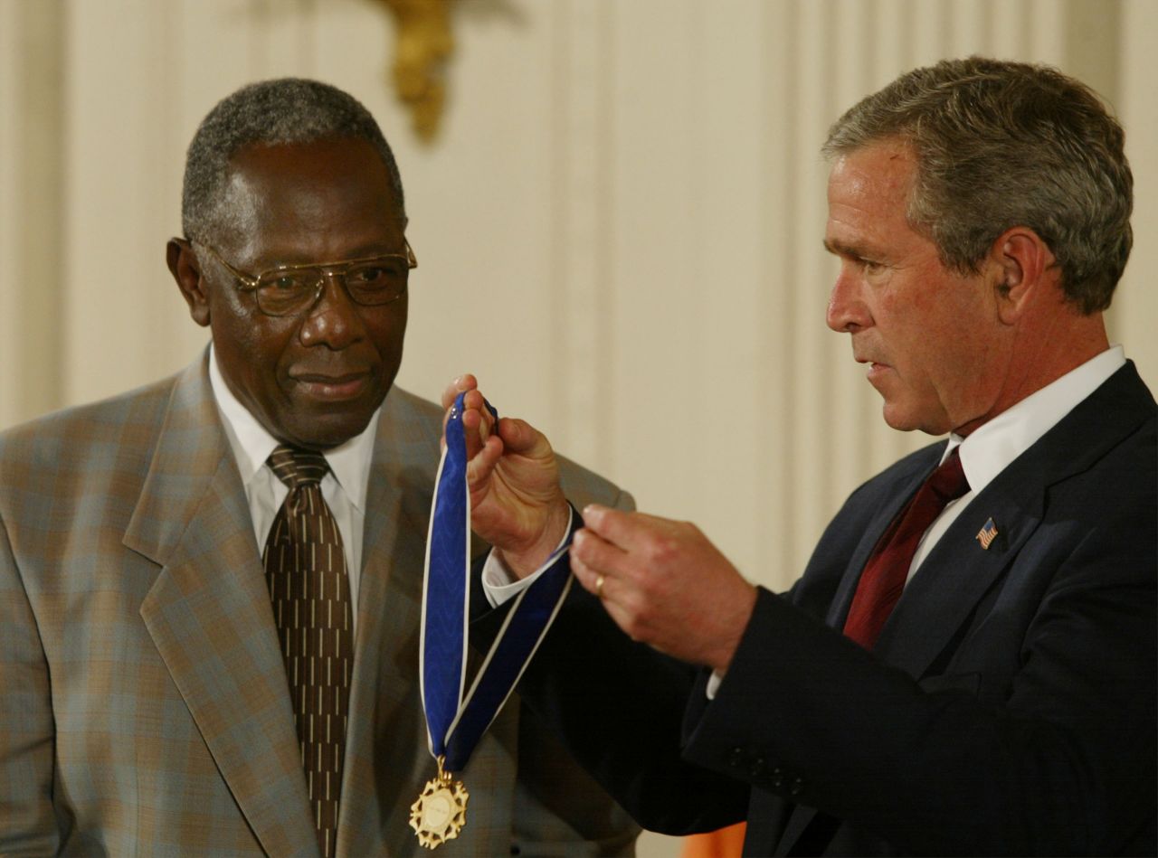 President George W. Bush presents Aaron with the Presidential Medal of Freedom in 2002. "By steadily pursuing his calling in the face of unreasoning hatred, Hank Aaron has proven himself a great human being, as well as a great athlete," Bush said during the ceremony.