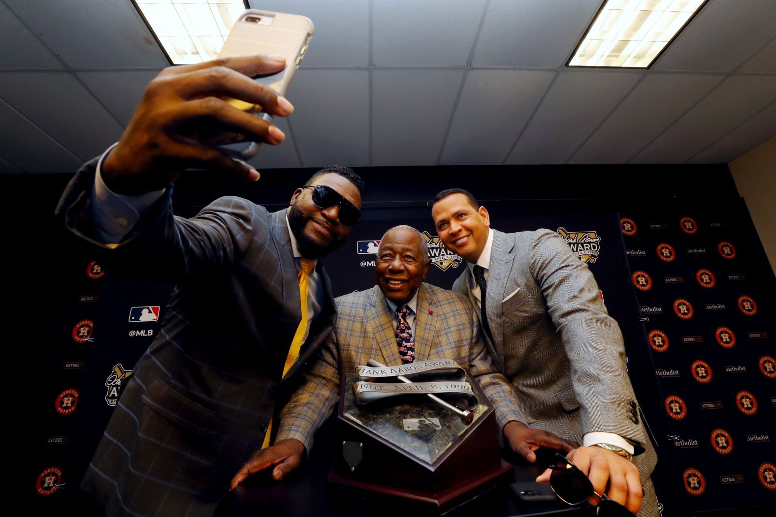 Aaron poses with former players David Ortiz, left, and Alex Rodriguez in 2019.