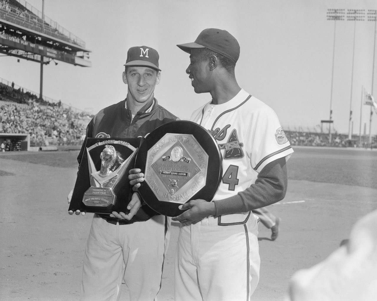 Aaron holds his MVP award with Braves pitcher Warren Spahn, who won the Cy Young Award that year.