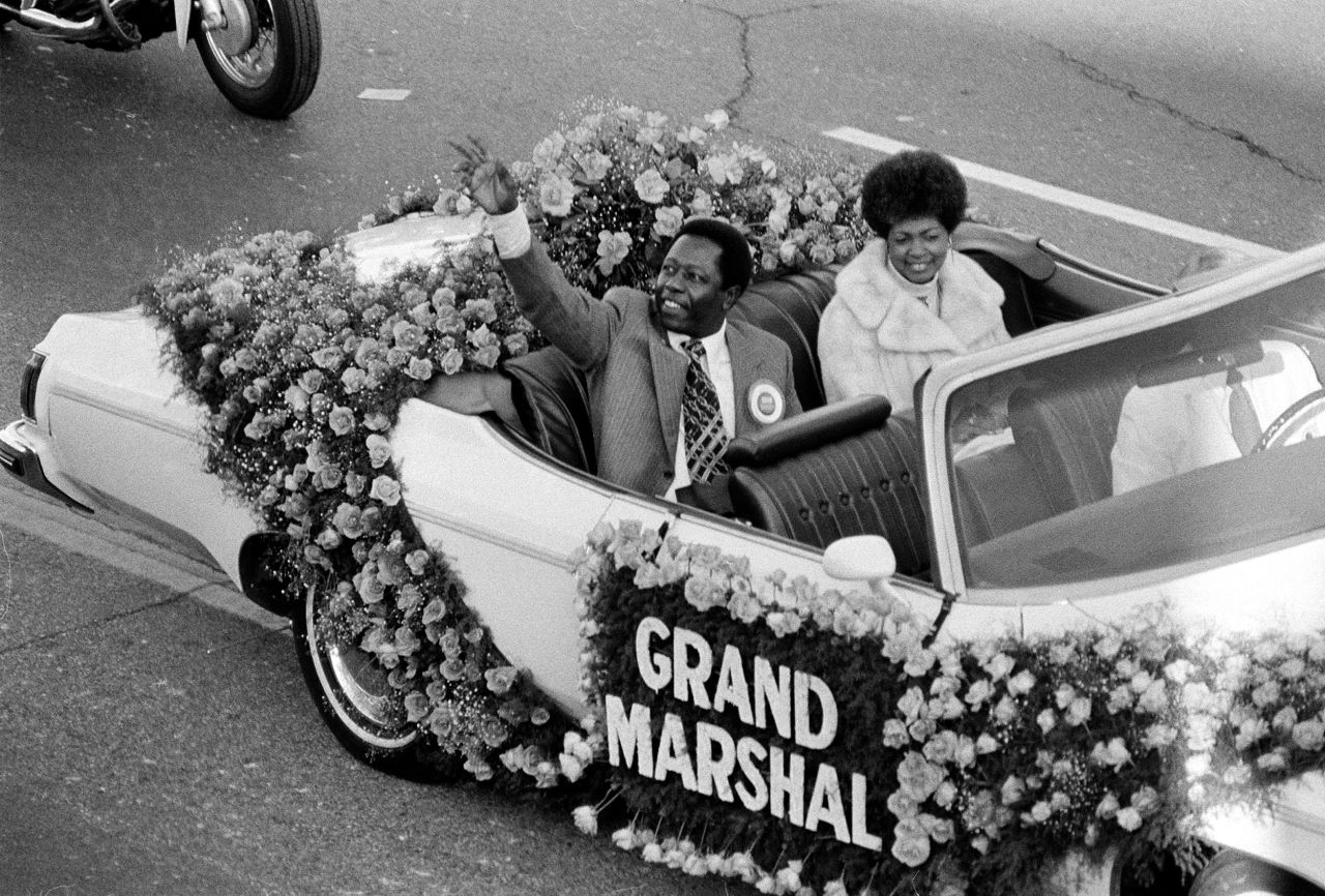 Aaron waves to the crowd as grand marshal of the Tournament of Roses parade in Pasadena, California, in 1975. Riding with him in the car is his second wife, Billye.