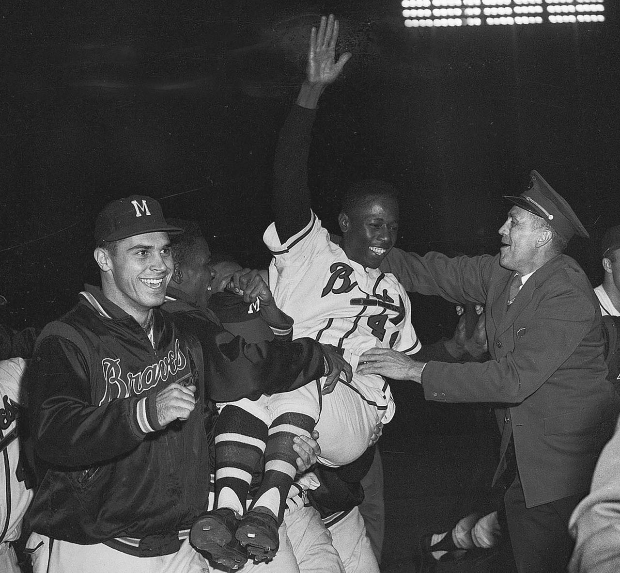 Aaron is carried off the field by his teammates after Milwaukee won the National League pennant in 1957.