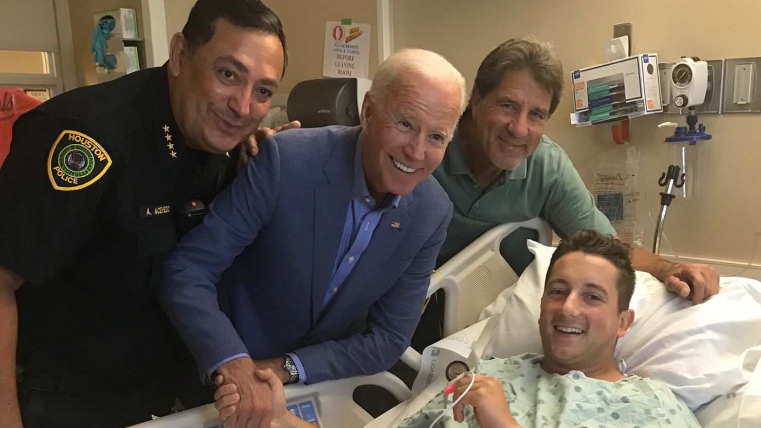 Officer Taylor Roccaforte was recovering from gunshot wounds when then-candidate Joe Biden came to see him in the hospital. His father, Samuel Roccaforte (right), and Houston Police Chief Art Acevedo, were also at his bedside.