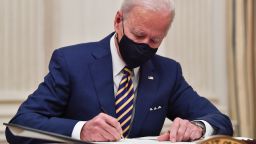 US President Joe Biden signs executive orders for economic relief to Covid-hit families and businesses in the State Dining Room of the White House in Washington, DC, on January 22, 2021. 