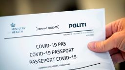 Picture taken on July 10, 2020 shows a Covid-19 passport printed from a website in Copenhagen, on July 10, 2020. - With the new Covid-19 passport issued be the Danish authorities, Danes now have official documentation for testing on their travels abroad. 