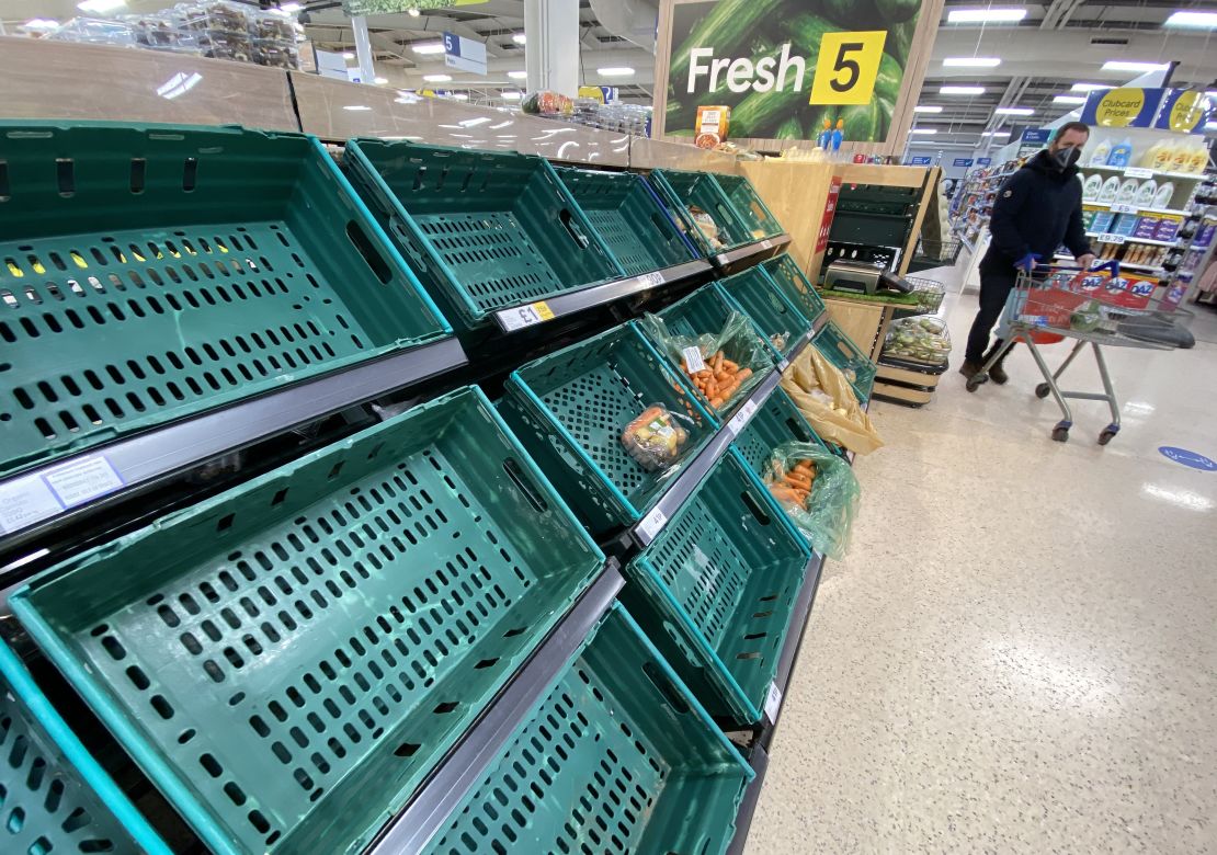 A supermarket customer looks at the near empty shelves in Tescos on January 14, 2021 in Belfast, Northern Ireland. 