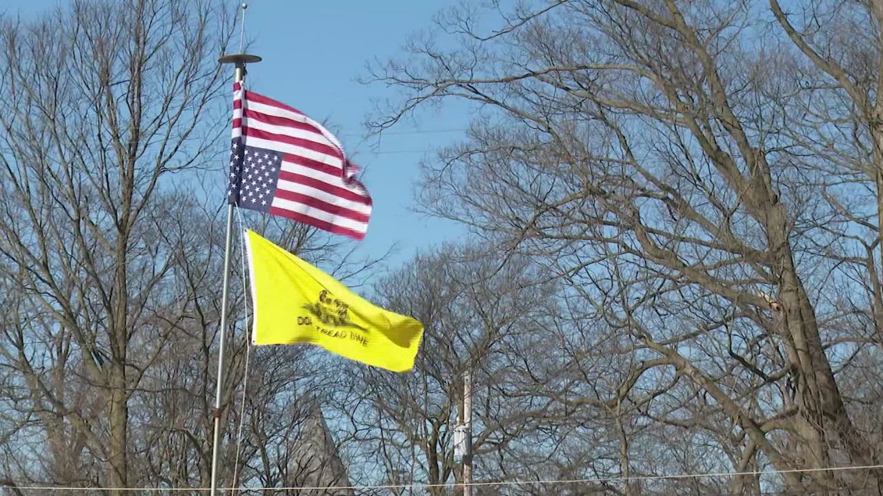 An upside-down Stars and Strips and a "Don't Tread on Me" Gadsden flag suggest anti-government feeling in Woodstock, Ohio.