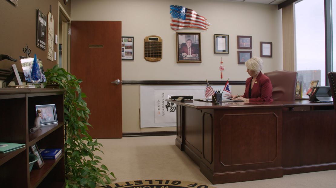 Mayor Louise Carter-King, the first woman mayor of Gillette, says she supports the United States rejoining the Paris Climate Accord. Her father, Herb Carter, framed in the background, served as mayor in the 1980s.