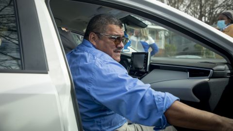 Chicas reaches to shut the car door as he leaves the North Carolina church grounds where he has lived in sanctuary since 2017. The 55-year-old Salvadoran immigrant says a new Biden administration policy pausing most deportations for 100 days gave him the chance to return home.