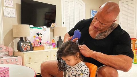 Dwayne Johnson and his daughter Tiana Gia as she lets him untangle her hair. 