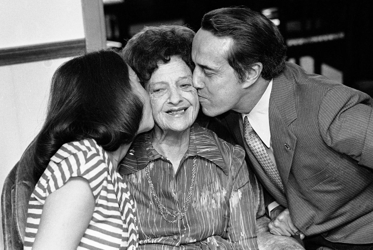 Dole and his daughter, Robin, kiss Dole's mother, Bina, on Mother's Day in 1979.