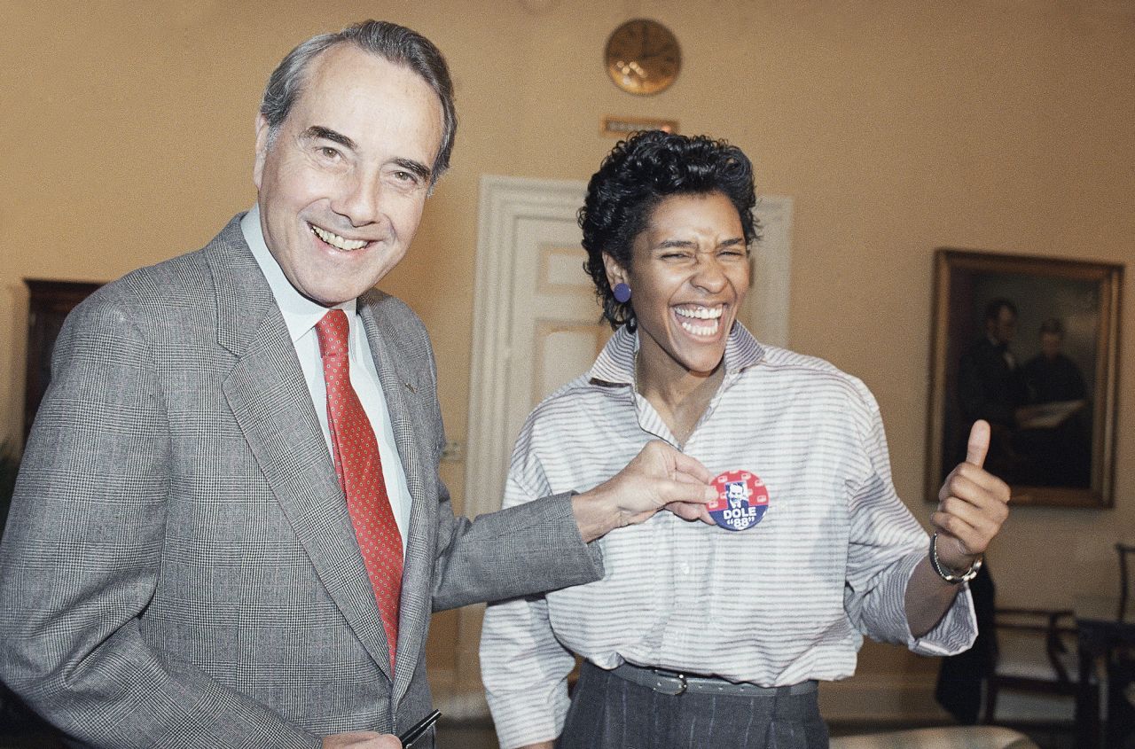 Dole ran for president again in 1988. Here, he holds a campaign button in front of Lynette Woodard of the Harlem Globetrotters.