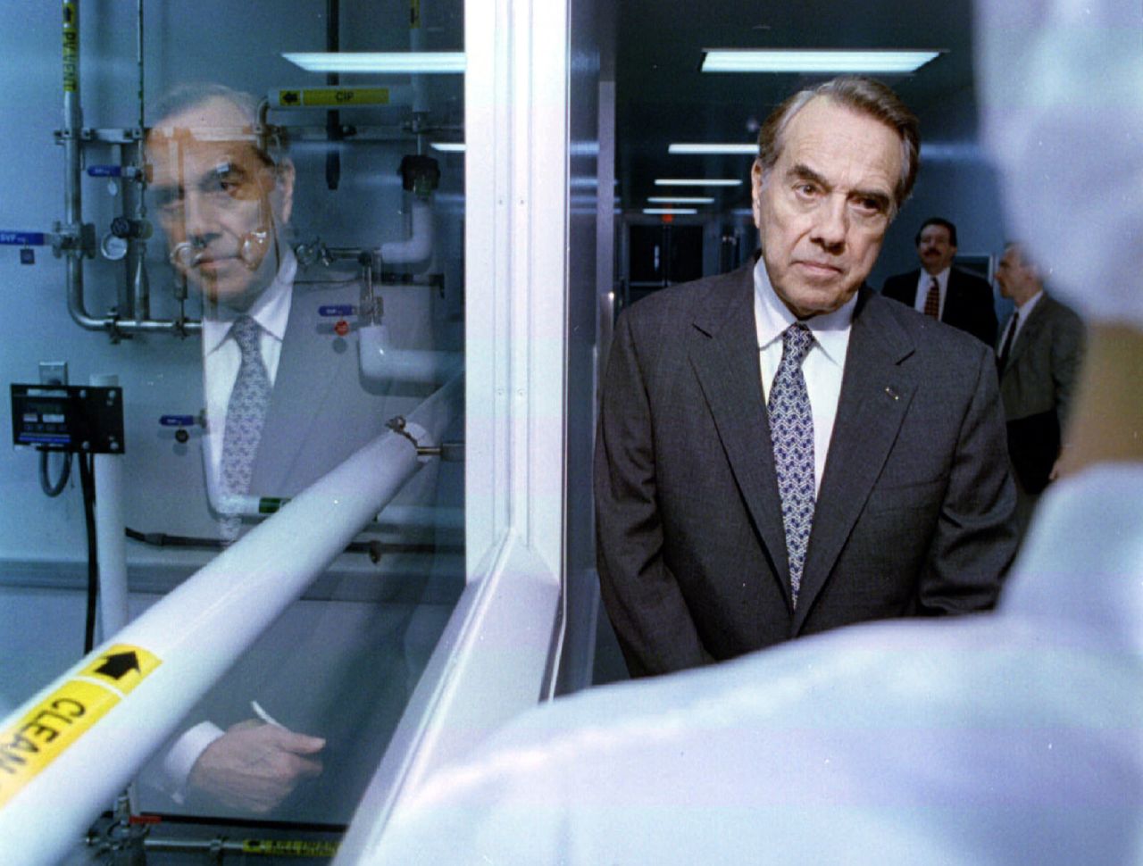 Dole listens to a technician during a campaign stop at a pharmaceutical company in Portsmouth, New Hampshire, in 1996.