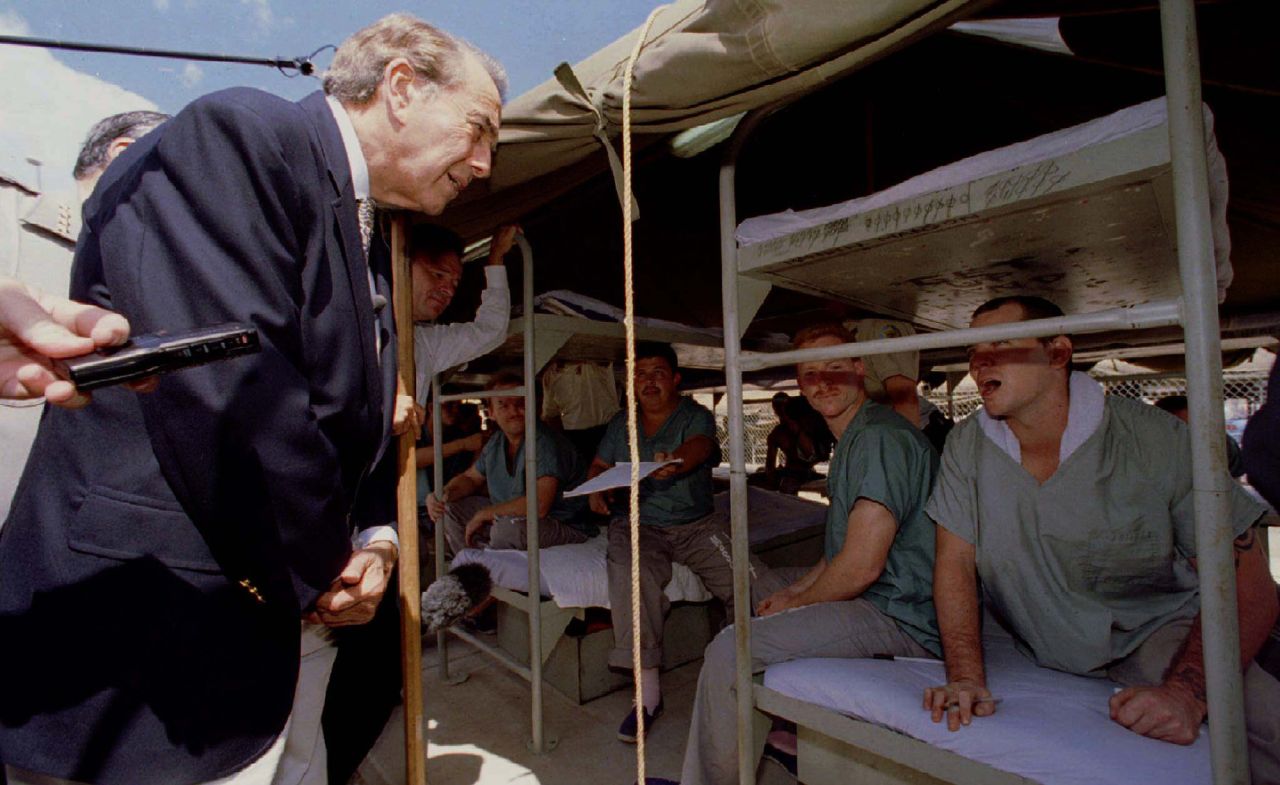 Dole talks with a prisoner at the Durango Jail's "Tent City'' during a campaign visit in Phoenix in 1996. The outdoor jail, which housed approximately 1,200 male and 200 female prisoners at the time, was the site of Dole's speech about crime issues.
