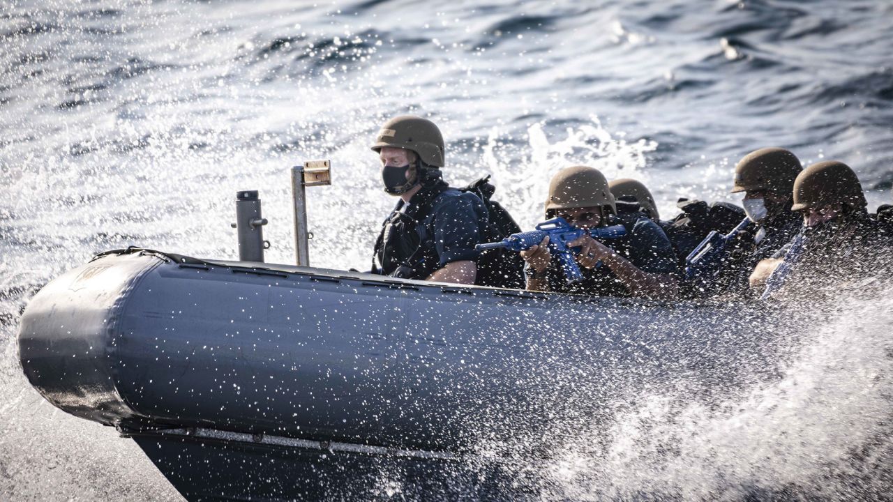 SOUTH CHINA SEA (Jan. 15, 2021) Sailors conduct "horseshoe maneuvers" in a rigid-hull inflatable boat prior to boarding the Arleigh Burke-class guided-missile destroyer USS John S. McCain (DDG 56) during a visit, board, search and seizure drill. John S. McCain is assigned to Destroyer Squadron (DESRON) 15, the Navy's largest forward-deployed destroyer squadron and the U.S. 7th Fleet's principal surface force. (U.S. Navy photo by Mass Communication Specialist 2nd Class Markus Castaneda) 210115-N-WI365-2117
