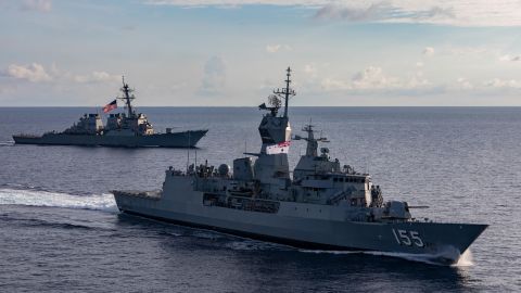 The US guided-missile destroyer USS John S. McCain, rear, and the Royal Australian Navy HMAS Ballarat sail together during integrated operations in the South China Sea in October.