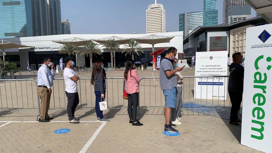 People line up at a vaccination facility in Dubai's financial center district on January 24, 2021. 