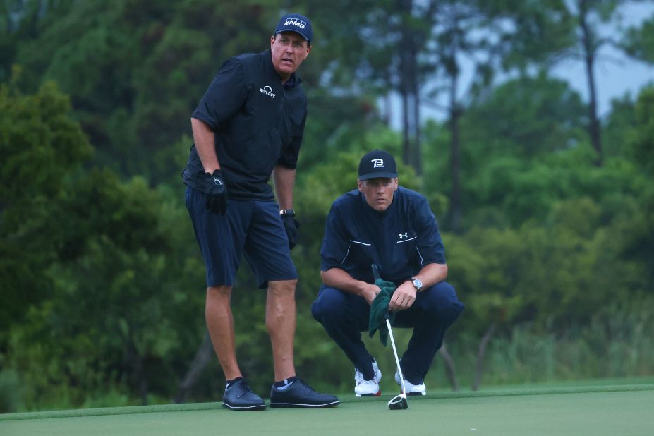 Pro golfer Phil Mickelson reads a putt for Brady as they team up for a made-for-TV charity match in May 2020. Mickelson and Brady lost a close match to Tiger Woods and Peyton Manning.