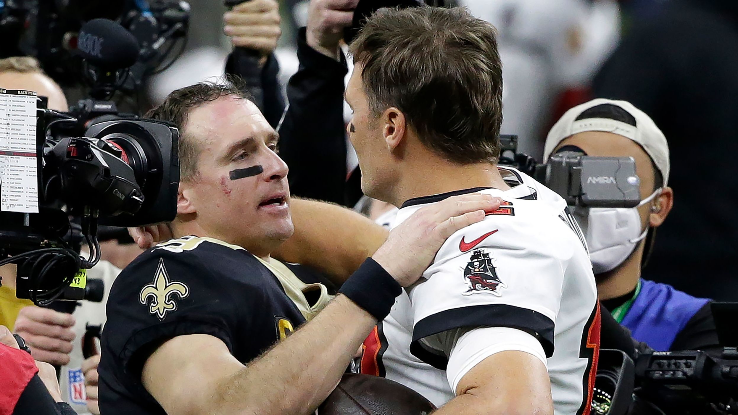 New Orleans quarterback Drew Brees congratulates Brady after the Buccaneers defeated Brees' Saints in an NFL playoff game in January 2021. It was the first playoff game in NFL history to feature two starting quarterbacks in their 40s. Both players occupy the top two spots for many of the league's quarterback records.