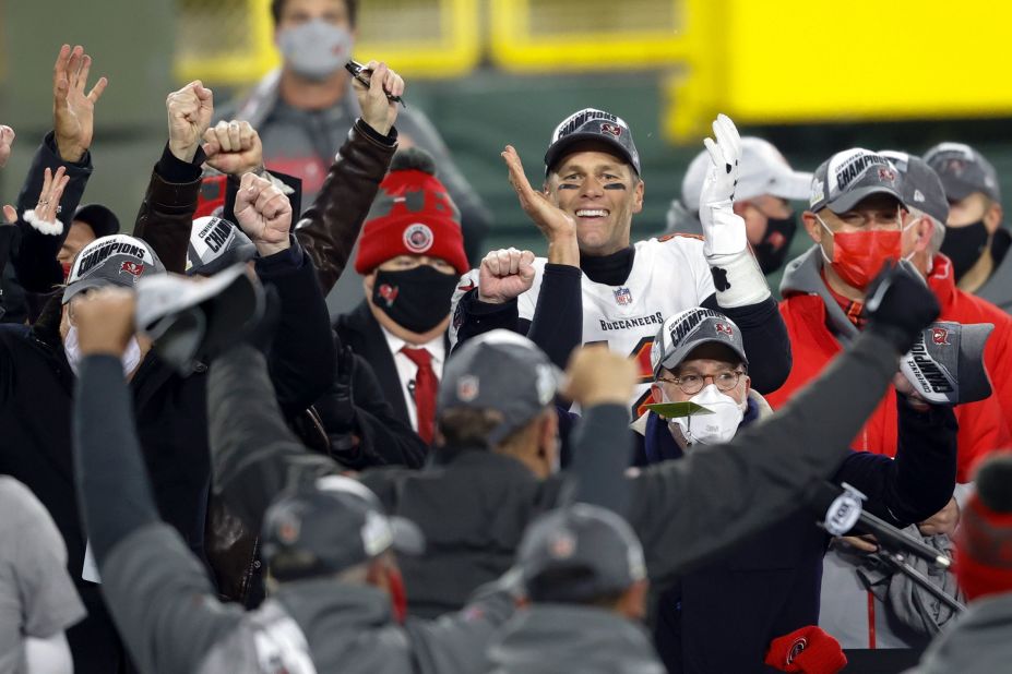 Brady celebrates with his teammates in January 2021 after Tampa Bay defeated Green Bay to win the NFC and clinch a spot in the Super Bowl.