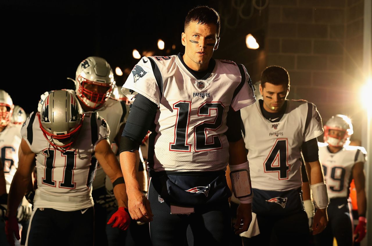 Brady leads his team onto the field before a game against the New York Jets in 2019.