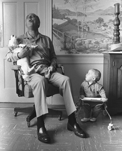 Lyndon B. Johnson sings with his dog Yuki while his grandson Patrick looks on in 1968. Johnson's daughter rescued Yuki, a mixed-breed dog who was abandoned at a gas station in Texas.