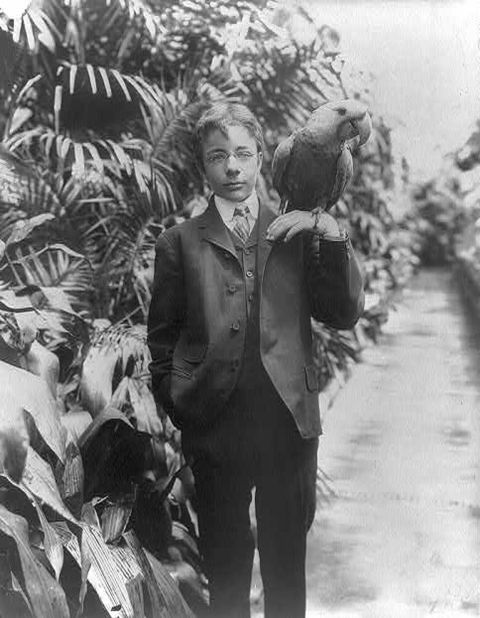 President Theodore Roosevelt's eldest son, Teddy Jr., holds a macaw named Eli circa 1902. The Roosevelts had all kind of animals, including lizards, snakes and a one-legged chicken.