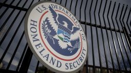 The U.S. Department of Homeland Security (DHS) seal hangs on a fence at the agency's headquarters in Washington, D.C., U.S., on Thursday, Dec. 11, 2014. The U.S. House is set to pass a $1.1 trillion spending bill that includes a banking provision opposed by many Democrats as a giveaway to large institutions. Current funding for the government ends today, and the measure would finance most of the government through September 2015. The DHS, responsible for immigration policy, would be financed only through Feb. 27. Photographer: Andrew Harrer/Bloomberg via Getty Images