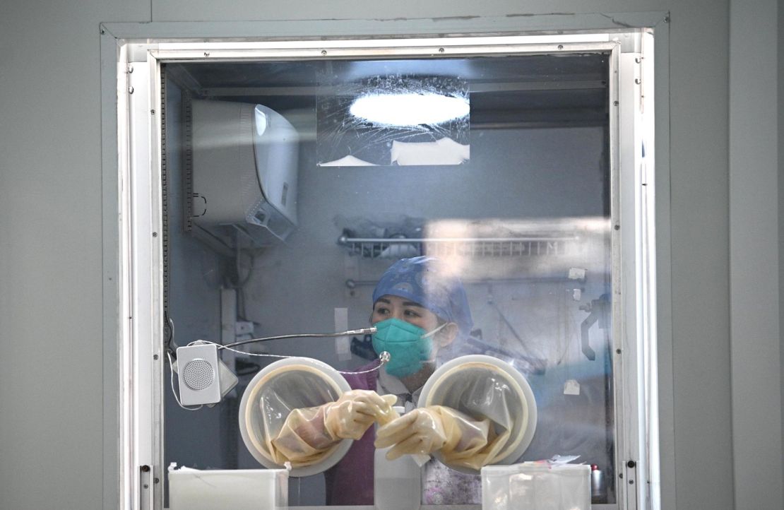 A medical worker waits at a nucleic acid testing centre at a hospital in the Daxing district of Beijing on January 22, 2021, after a partial lockdown was imposed on the Chinese capital.