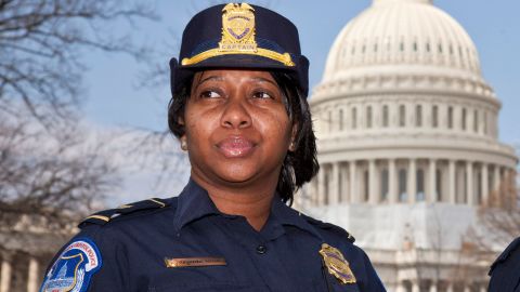 Officers Yogananda "Yogi" Pittman, left, and Monique Moore, right, the first two African-American women to be promoted to the rank of captain on the U.S. Capitol Police force, stand together on the East Lawn of the Capitol in Washington, Monday, March 19, 2012. (AP Photo/J. Scott Applewhite)