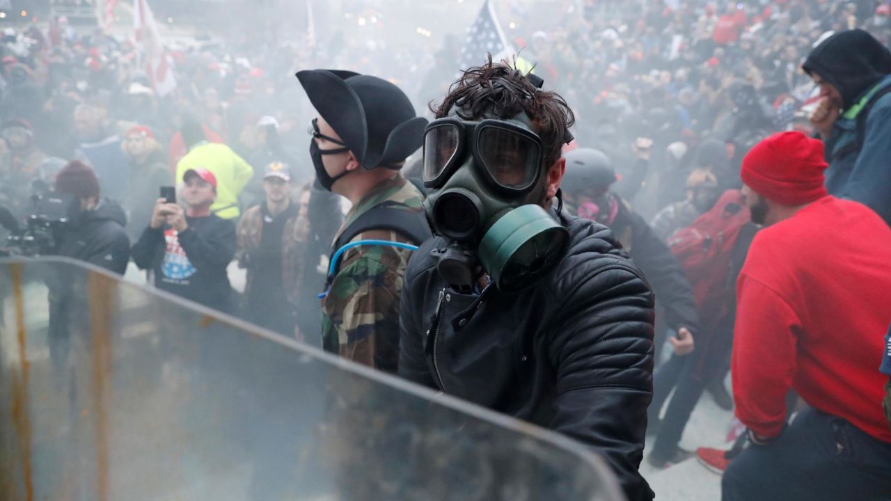 Prosecutors said in court documents that the man pictured in a gas mask appears to be Lang.