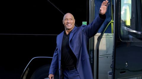 Dwayne Johnson waves to supporters in a scene from NBC's "Young Rock." 