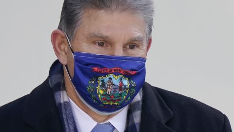 Sen. Joe Manchin, here at President Biden's inauguration, represents West Virginia in Congress and on his mask.
