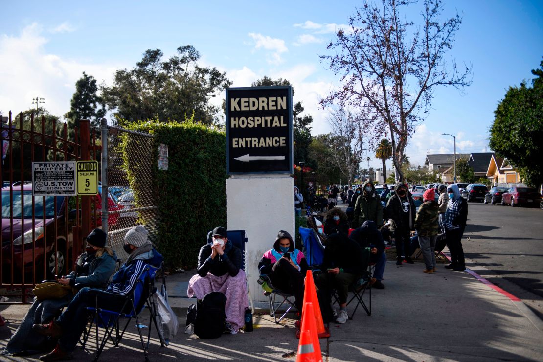 People without appointments wait in line for the potential chance to receive a Covid-19 vaccination that would have otherwise been discarded at the Kedren Community Health Center on January 25 in Los Angeles.