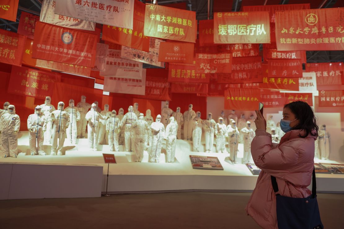 A woman wears a protective mask as she visits an exhibition in Wuhan, China, on the city's fight against the coronavirus, on January 26, 2021.