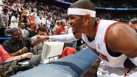 Josh Smith of the Atlanta Hawks bumps fists with sportswriter Sekou Smith before the tipoff against the Cleveland Cavaliers during the 2009 Eastern Conference Semifinals at Philips Arena in Atlanta.