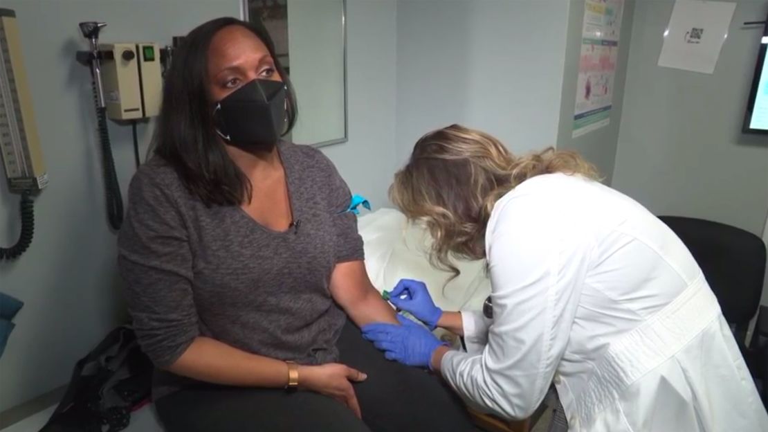 Elam prepares to get her blood drawn by nurse practitioner Amber Mottola.