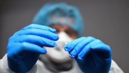 A medical assistant wearing protective mask, gloves and garment processes a sample from a rapid antigen test for the novel coronavirus (Covid-19) at the reception of the nursing home for seniors 'Schmallenbach Haus' in Froendenberg, western Germany, on January 22, 2021. - Every visitor, employee and resident of the nursing home is regularly checked with the rapid antigen tests for Covid-19 upon entering. (Photo by Ina FASSBENDER / AFP) (Photo by INA FASSBENDER/AFP via Getty Images)