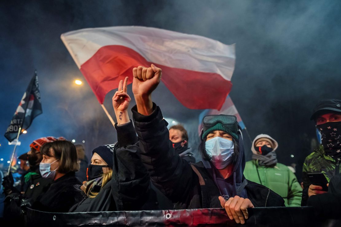 A demonstrator gestures as people take part in a pro-choice protest in the center of Warsaw, on January 27, 2021, as part of a nationwide wave of protests since October 22, 2020 against Poland's near-total ban on abortion. - A demonstrator holds a banner reading "Abortion on demand" as she takes part in a pro-choice protest in the center of Warsaw, on January 27, 2021, as part of a nationwide wave of protests since October 22, 2020 against Poland's near-total ban on abortion. A controversial Polish court ruling that imposes a near-total ban on abortion will come into force on January 27, 2021, the country's right-wing government said, in an announcement that triggered protests. (Photo by Wojtek RADWANSKI / AFP) (Photo by WOJTEK RADWANSKI/AFP via Getty Images)