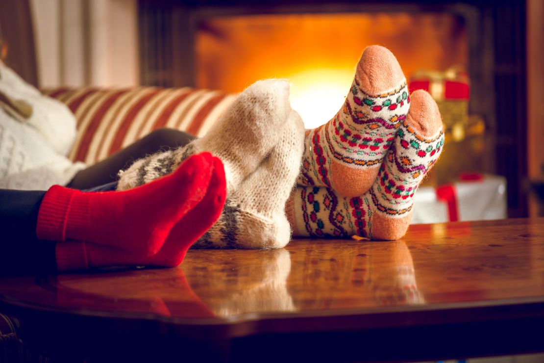 Cozying up underneath layers of clothing or blankets (or both) can help insulate you from the cold.