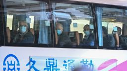 Members of the World Health Organization (WHO) team investigating the origins of the Covid-19 coronavirus pandemic leave The Jade Hotel on a bus after completing their quarantine in Wuhan, Chinas central Hubei province on January 28, 2021. (Photo by Hector RETAMAL / AFP) (Photo by HECTOR RETAMAL/AFP via Getty Images)