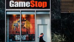 A pedestrian wearing a protective mask walks past a a GameStop Corp. store in the Herald Square area of New York, U.S., on Friday, Nov. 27, 2020. With sparse crowds and none of the stampedes of holidays past, some retail watchers started to refer to Black Friday as Blase Friday instead -- and that was even before the virus hit. Photographer: Gabriela Bhaskar/Bloomberg via Getty Images