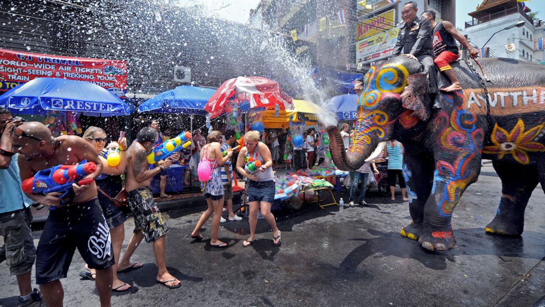 <strong>Songkran, 2010: </strong>An elephant spouts water over tourists during the Songkran festival to mark the Thai new year in April, 2010. Khao San Road has long been a popular spot for tourists and locals looking to join the world-famous Songkran water fights. 