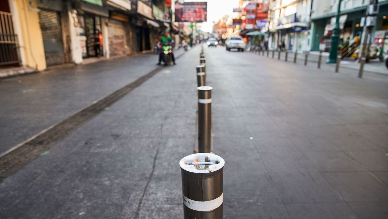 <strong>Controlling the chaos: </strong>The Bangkok Metropolitan Authority recently invested $1.6 million to transform Khao San Road into a regulated "international walking street."  The project wrapped up in late 2020, with a repaved road and footpaths, and retractable bollards (pictured) designating spaces for 250--350 licensed Thai vendors.<br />