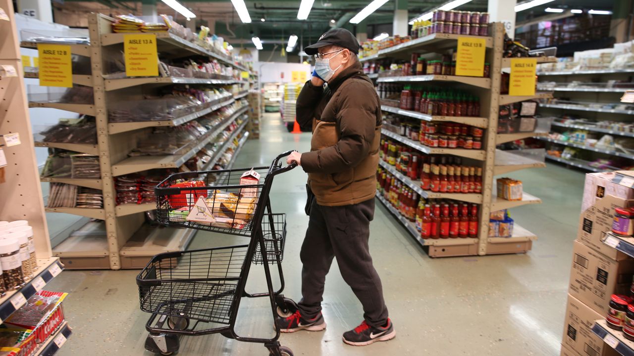 Check Chen from Seattle, shops for groceries during special hours open to seniors only at Uwajimaya, an Asian specialty supermarket, on March 18, 2020 in Seattle.