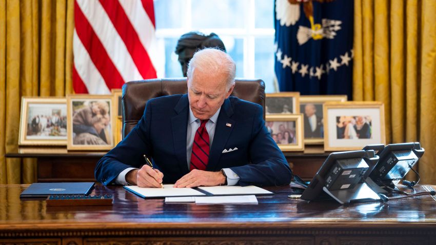U.S. President Joe Biden signs executive actions in the Oval Office of the White House on January 28, 2021 in Washington, DC. President Biden signed a series of executive actions Thursday afternoon aimed at expanding access to health care, including re-opening enrollment for health care offered through the federal marketplace created under the Affordable Care Act. 