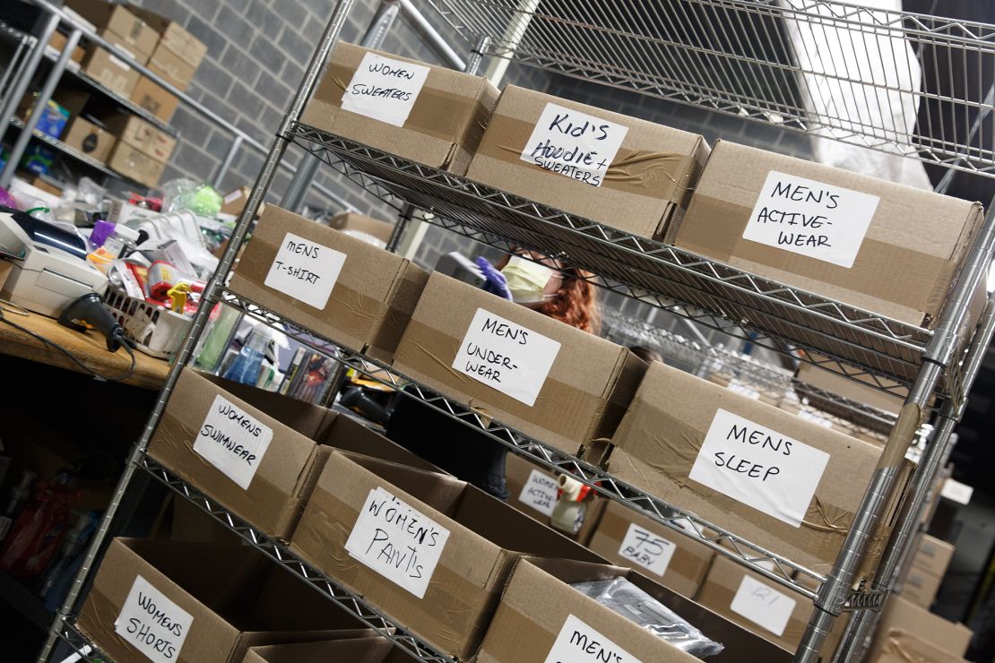 An employee sorts through a pile of returns and categorizes each item to eventually be sold to a reseller.