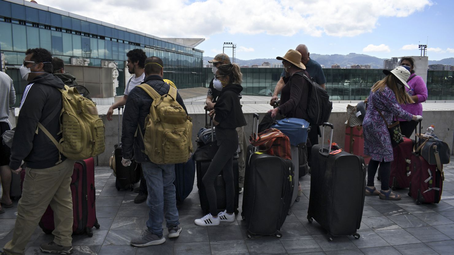 Travellers wait in line for a charter flight coordinated by the United States embassy to take them back home, at the La Aurora international airport in Guatemala City on March 23, 2020. - The United States is trying to repatriate some 13,500 Americans stranded overseas by the coronavirus pandemic but does not believe it can reach all of them, the State Department said Monday. (Photo by Johan ORDONEZ / AFP) (Photo by JOHAN ORDONEZ/AFP via Getty Images)